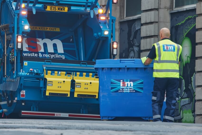 ISM waste operative collecting customer wheelie bin