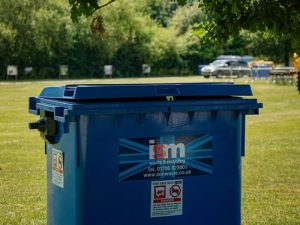 ISM 1100 litre wheelie bin in field for outdoor event