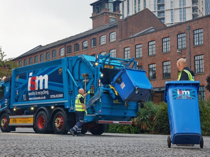 ISM staff emptying wheelie bins at a customers site