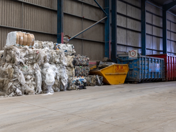 stacked up bales of plastic in recycling facility