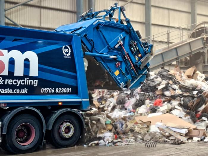 ISM waste collection truck tipping waste in MRF